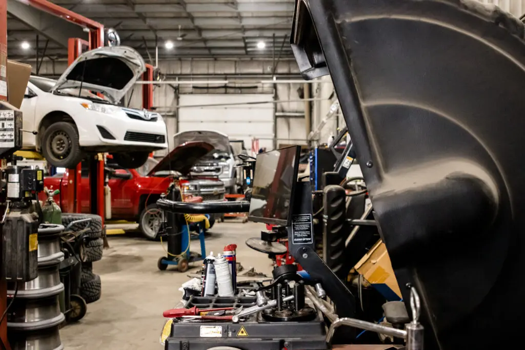 Red Deer Red Seal mechanic performing a preventative maintenance inspection under the hood of a customer vehicle