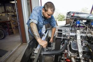 Mechanic Repairing Engine In Auto Repair Shop