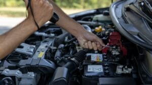 Man is Checking car battery because car battery is depleted. concept car maintenance