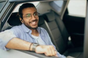 Young indian guy listening to music in car