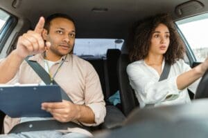 Arabic Instructor Man Providing Driving Lessons to Aspiring Driver Woman