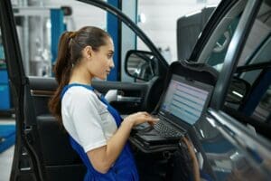 Female mechanic does diagnostics, car service